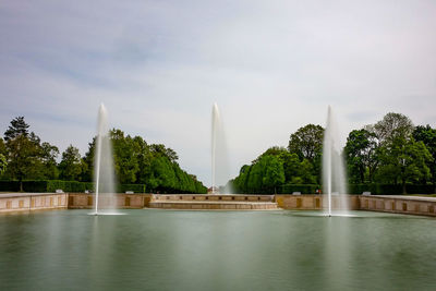 Fountain in lake against sky