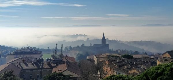 Panoramic view of buildings in city against sky