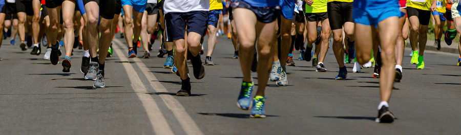 Low section of people walking on street