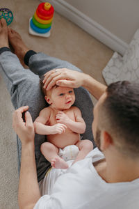 High angle view of father playing with daughter