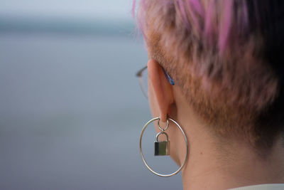 Close-up of young woman wearing earrings