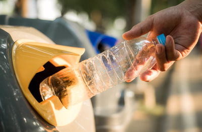 Close-up of hand holding glass bottle