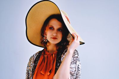 Portrait of beautiful young woman against white background