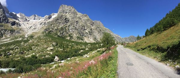 Panoramic view of road amidst mountains against clear sky