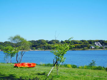 Scenic view of lake against clear blue sky