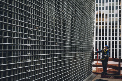 Man working at construction site against building