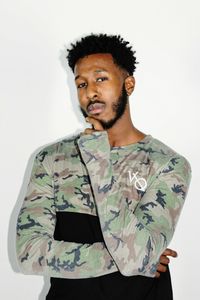 Portrait of young man standing against white background