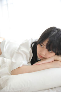 Young woman sleeping on bed at home