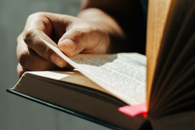 Close-up of hand holding book