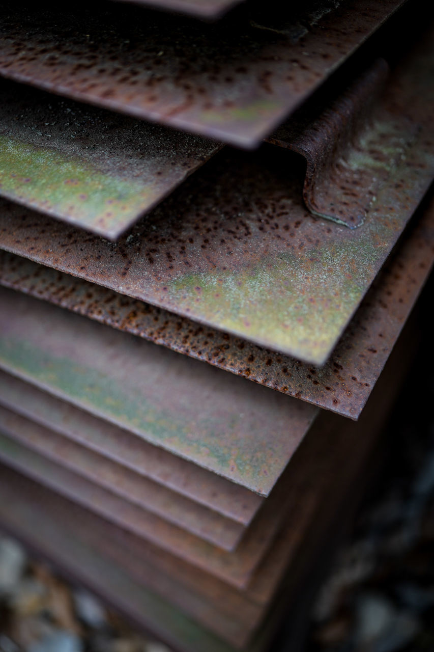 HIGH ANGLE VIEW OF OLD RUSTY METAL ON WOOD