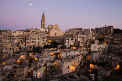 Buildings in city against clear sky