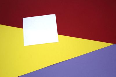 High angle view of yellow paper against wall