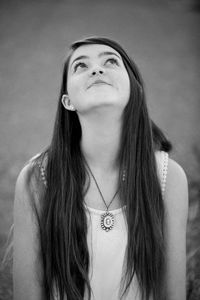 Young woman looking away against blurred background