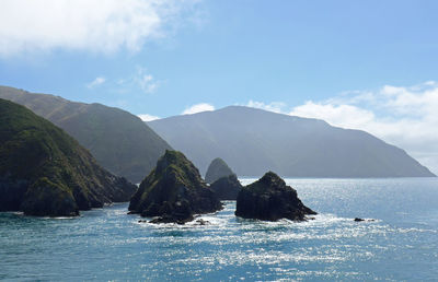 Panoramic view of sea and mountains against sky