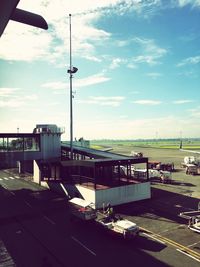 Airplane on airport runway against sky