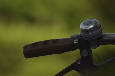 Close-up of bicycle handlebar against blurred background