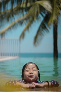 Cute girl swimming in pool