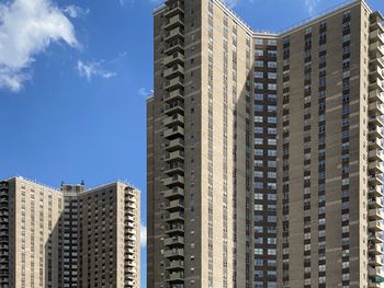 Low angle view of modern building against blue sky