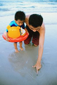 Rear view of boys on beach