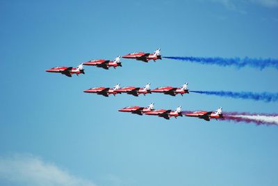 Low angle view of airshow against sky