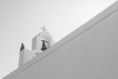 Low angle view of bell at church against sky