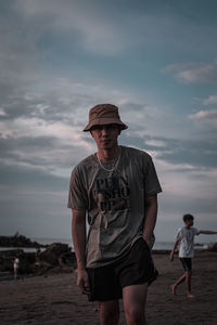 Full length of man standing at beach against sky