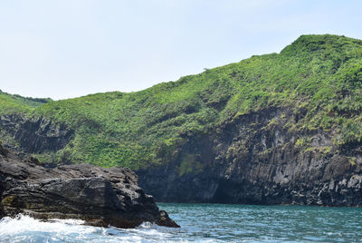 Scenic view of sea with mountains in background