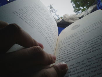 Close-up of hand holding book