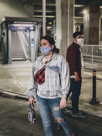 Full length portrait of people standing in city