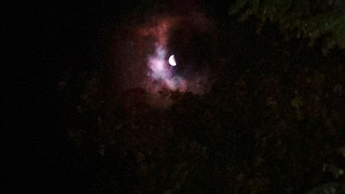 Low angle view of moon against sky at night