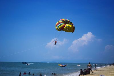 Parasailer flying high above sea