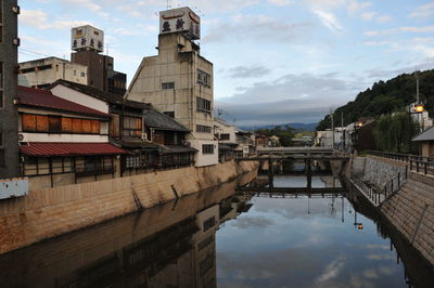 Buildings by canal in city