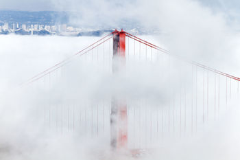 Golden gate bridge amidst clouds during foggy weather
