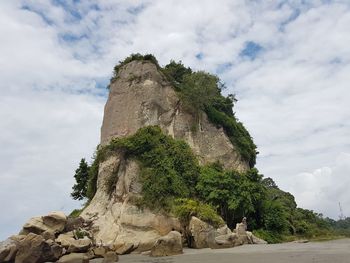 Low angle view of rock formation on mountain against sky