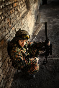 A thoughtful soldier, resting from a military operation location of ruins