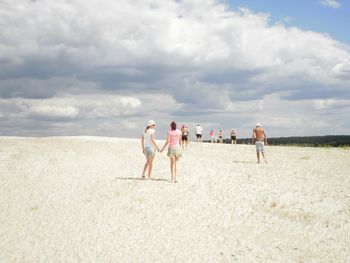 Scenic view of beach against cloudy sky