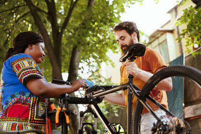 Side view of man riding bicycle on street