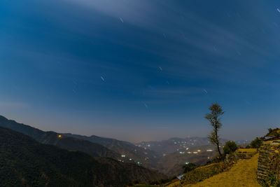 Scenic view of landscape against blue sky at night