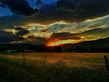 Scenic view of landscape against dramatic sky