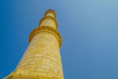 Low angle view of building against clear blue sky