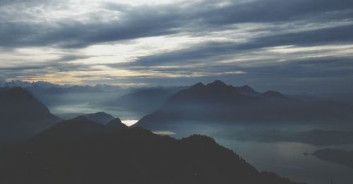 Scenic view of mountains against cloudy sky