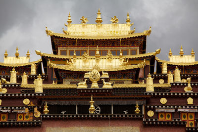 View of temple building against cloudy sky