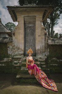 Portrait of woman wearing traditional clothing sitting on steps