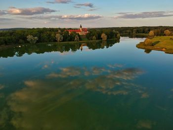 Scenic view of lake by building against sky