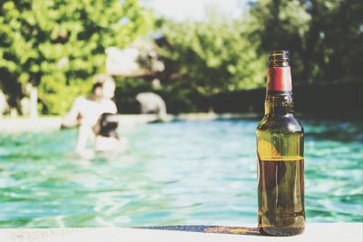 Beer bottle at the edge of pool