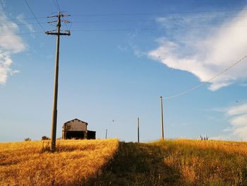 Windmill on field against sky