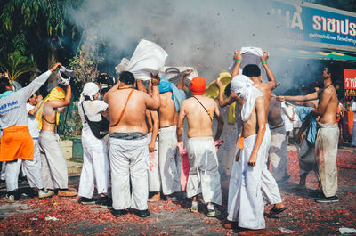 Rear view of people standing outdoors