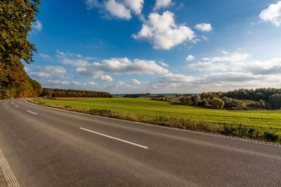 Street by road against sky