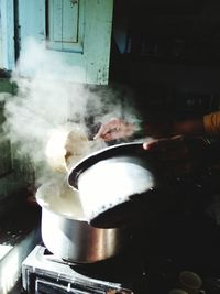 Cropped hands of woman preparing food in kitchen at home