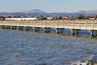 View of boats in sea against mountain range